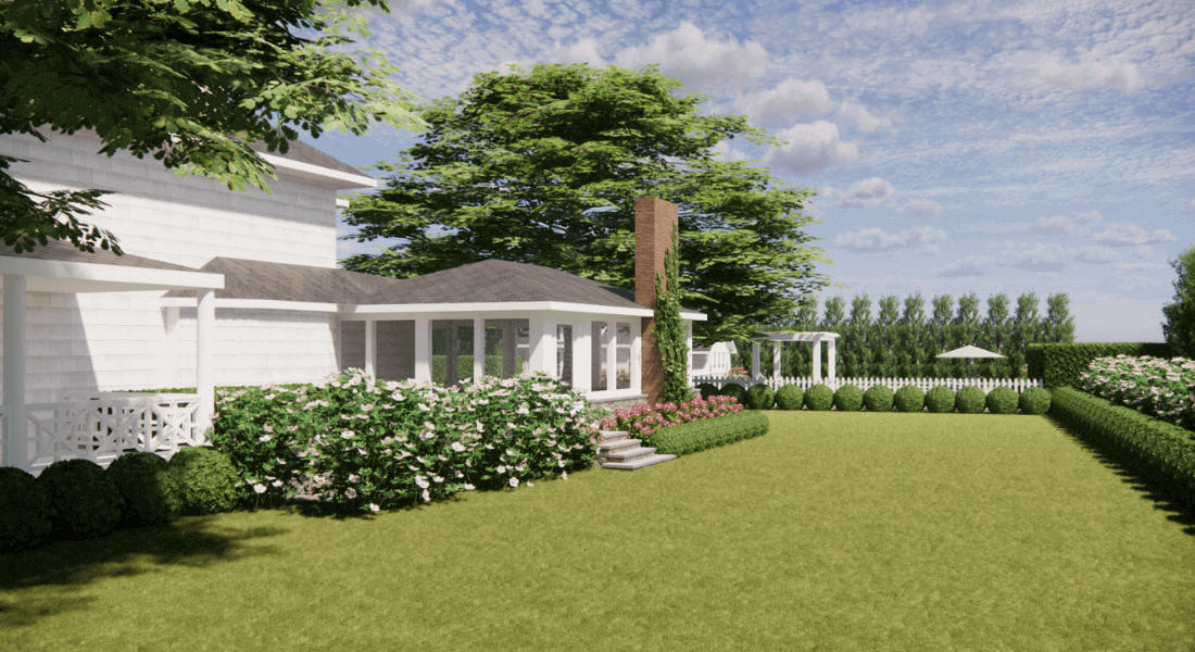 A landscaped backyard features a white house, patio with seating, flowering shrubs, manicured lawn, hedges, and trees under a partly cloudy sky.